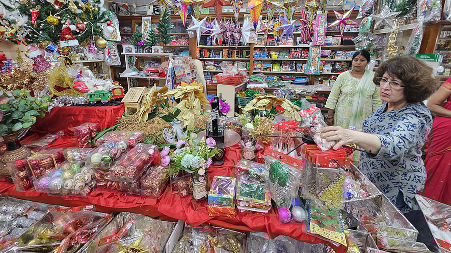 A customer selecting decorative materials at Gun Shop Little Shoppee at Camp in Belagavi wherein Christmas tree and other requirements for the festival decorations have been made available under one roof.