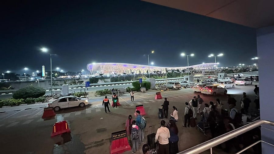 <div class="paragraphs"><p>Passengers wait for cabs at the new pickup zone, located about 700 metres from the arrivals, at the Kempegowda International Airport.  </p></div>