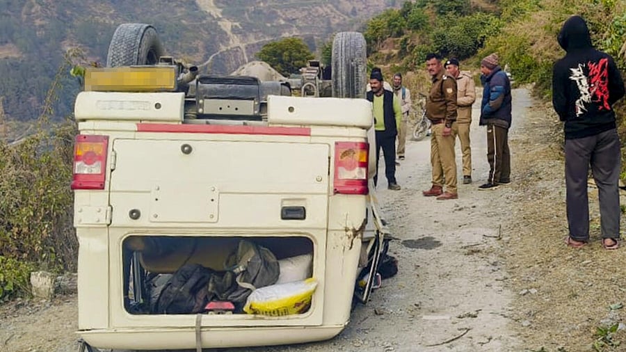 <div class="paragraphs"><p>Locals and police personnel gather near an overturned vehicle after it lost control on a turn and fell about 15 feet onto a lower road on the Kiruli-Pipalkoti motorway, leaving six of the eight occupants injured, in Chamoli district.</p></div>