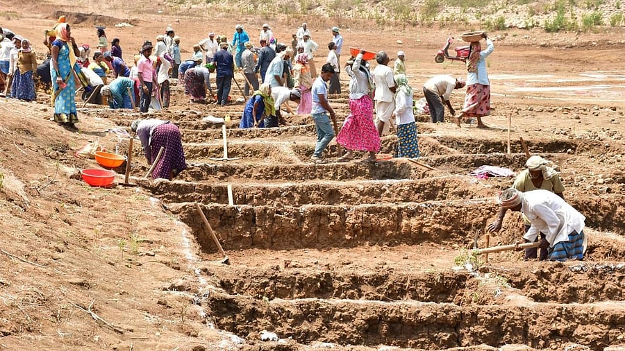 <div class="paragraphs"><p>Villagers desilt a lake under the MGNREGA scheme at a village in Dharwad district. </p></div>