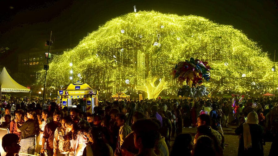 <div class="paragraphs"><p>People gather as the 80-foot tall 200-year-old rain tree is illuminated with lights and decoratives during the Christmas festival celebration, at Veli Ground, in Kochi, Kerala.</p></div>