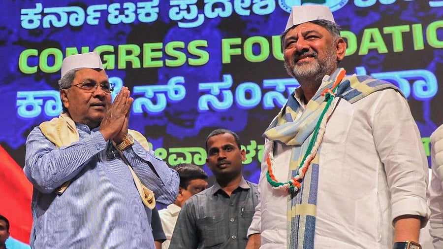 <div class="paragraphs"><p>Chief Minister Siddaramaiah greets the crowd as his deputy D K Shivakumar looks on at the Congress' foundation day event in Bengaluru on Sunday. </p></div>