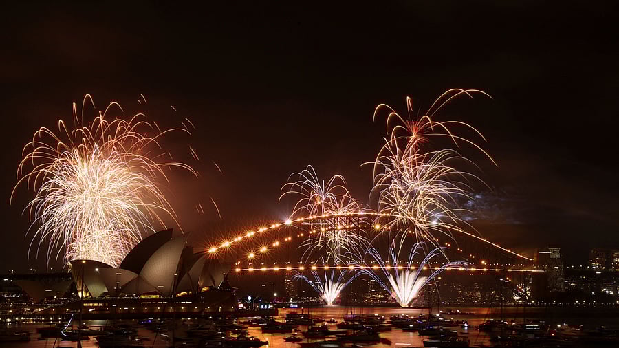 <div class="paragraphs"><p>Fireworks explode over Sydney Harbour Bridge at 9 p.m. during New Year's Eve celebrations, in Sydney</p><p></p></div>