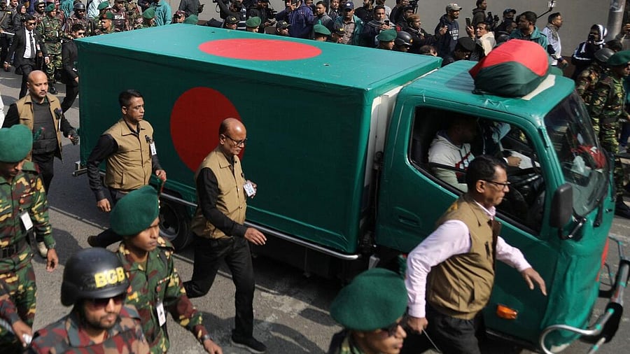 <div class="paragraphs"><p>Security forces escort a flag-draped vehicle carrying the mortal remains of Bangladesh's former Prime Minister Khaleda Zia for her funeral in Dhaka, Bangladesh.</p></div>