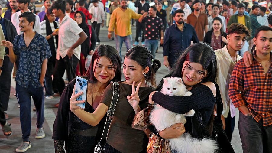 <div class="paragraphs"><p>A reveller with her pet during New Year celebrations at&nbsp;Koramangala. </p></div>