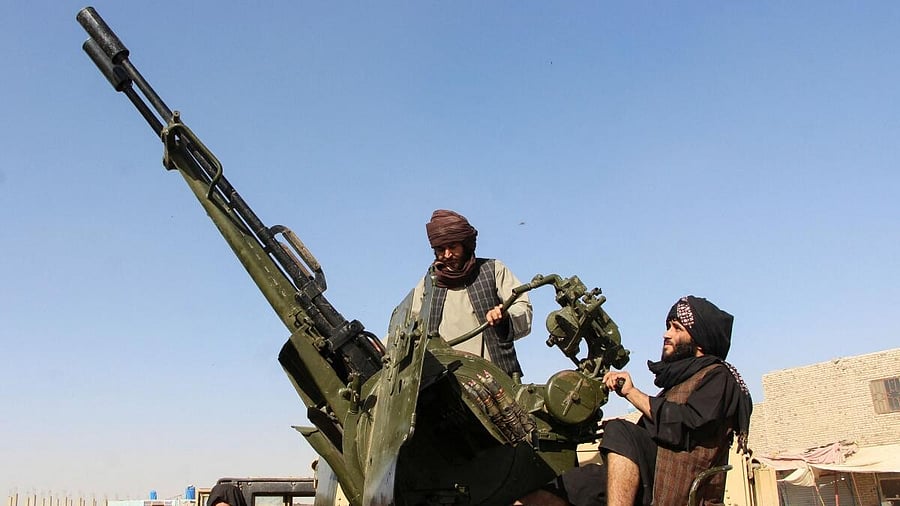 <div class="paragraphs"><p>An Afghan Taliban fighter sit next to an anti-aircraft gun near the Afghanistan-Pakistan border in Spin Boldak, Kandahar Province, following exchanges of fire between Pakistani and Afghan forces in Afghanistan.</p></div>