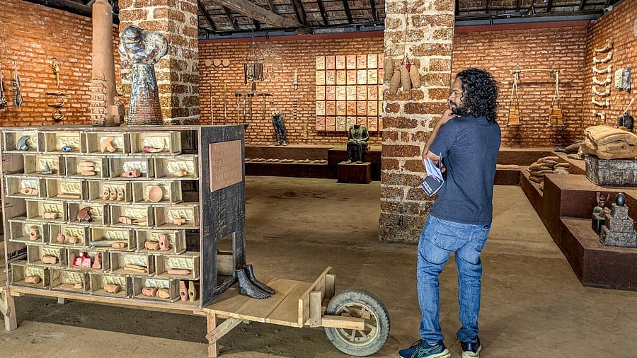 <div class="paragraphs"><p>A visitor looks at an installation work by artist Birender Yadav, at the Kochi-Muziris Biennale in Kochi, Kerala.</p></div>