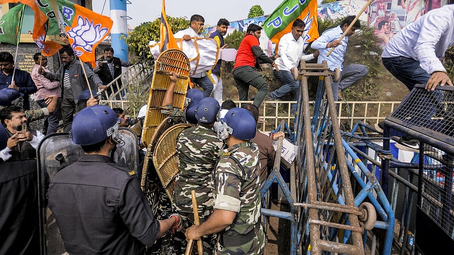 <div class="paragraphs"><p>Security personnel try to stop BJP supporters during a protest against the alleged killing of a Hindu youth in Bangladesh, near Howrah Bridge, Wednesday, Dec. 24, 2025</p></div>