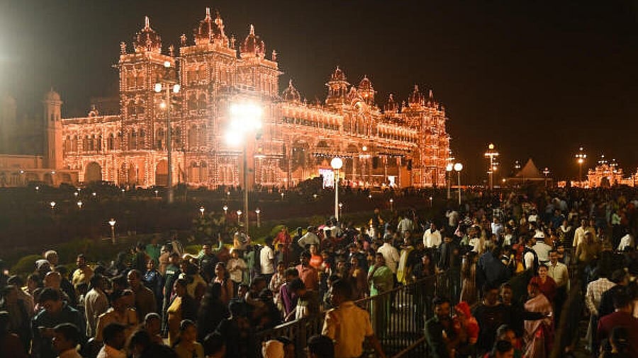 <div class="paragraphs"><p>Tourists at Illuminated Mysuru Palace premises.</p></div>