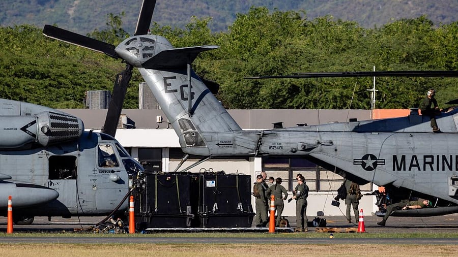 <div class="paragraphs"><p>Personnel stand next to a U.S. Marine Corps CH-53E Super Stallion helicopter parked on the tarmac at Mercedita International Airport, amid tensions between U.S. President Donald Trump's administration and the government of Venezuelan President Nicolas Maduro, in Ponce, Puerto Rico.</p></div>