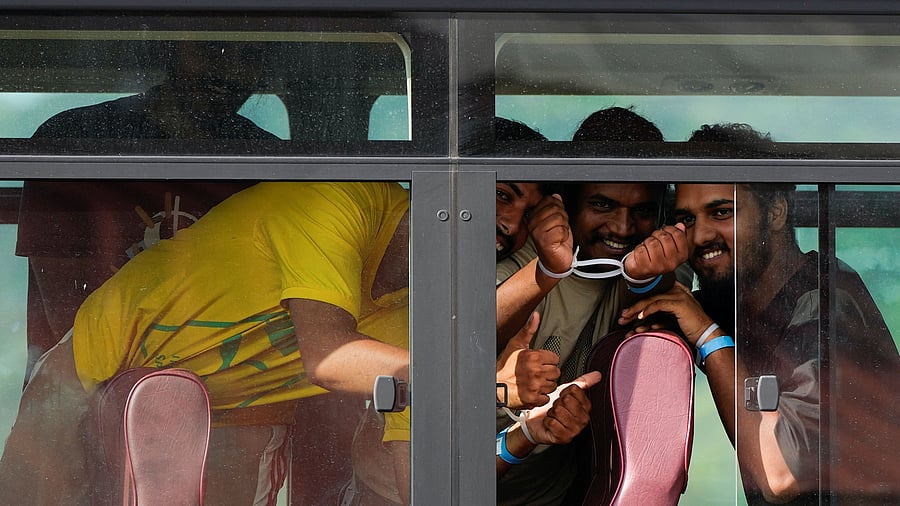<div class="paragraphs"><p>Handcuffed Indian migrants pose for a photo while being transported in a bus, before boarding a deportation flight bound for New Delhi, India, at Panama Pacifico Airport</p></div>