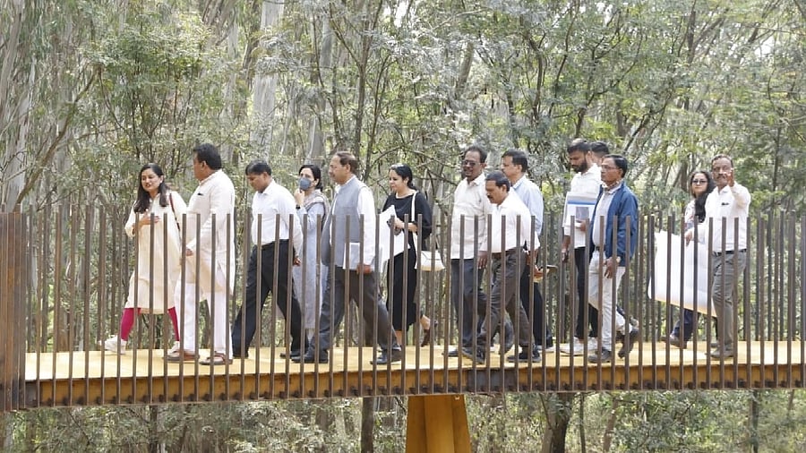 Industries Minister M B Patil, along with senior officials,
inspects works to develop a tree park on the premises of the defunct NGEF, in Bengaluru on Saturday. photo by spl arrangement