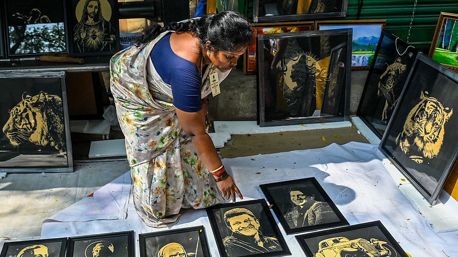 A vendor arranges art works depicting gods at the art fair.