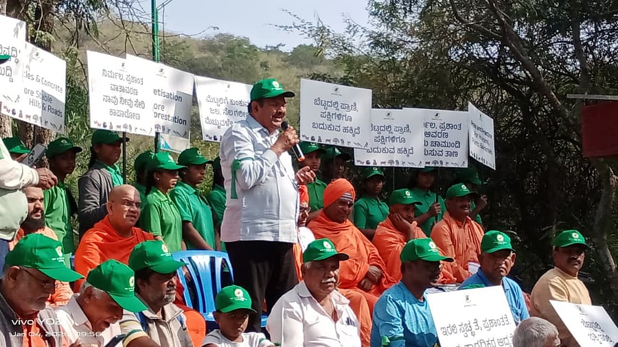 <div class="paragraphs"><p>President of Parisarakkaagi Naavu A T Ramaswamy addresses people who joined 'Save Chamundi Hill-Awareness walk' atop Chamundi Hill on Sunday morning. </p></div>