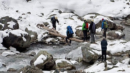 <div class="paragraphs"><p>Pahalgam: Ice climbers crossing a stream with the help of a log at Chandanwari at tourist resort of Pahalgam . Jammu and Kashmir Tourism Department has for the first time started ice climbing as an adventure sport in the valley.</p></div>