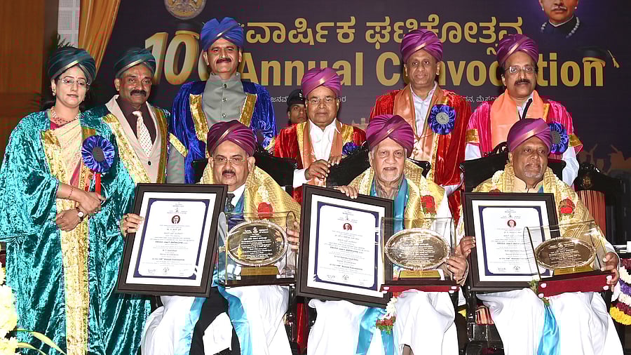 <div class="paragraphs"><p>Governor Thawar Chand Gehlot conferes honorary doctorate degrees on Chairman of Karnataka State Human Rights Commission T Sham Bhat, film-maker S V Rajendra Singh Babu and chairman of Global Education Trust P Jayachandra Raju during the 106th convocation of University of Mysore, in Mysuru, on Monday. Former chairman of ISRO S Somanath, Higher Education Minister M C Sudhakar, Vice-Chancellor N K Lokanath, Registrar M K Savitha, and Registrar (Evaluation) N Nagaraja are seen.</p></div>