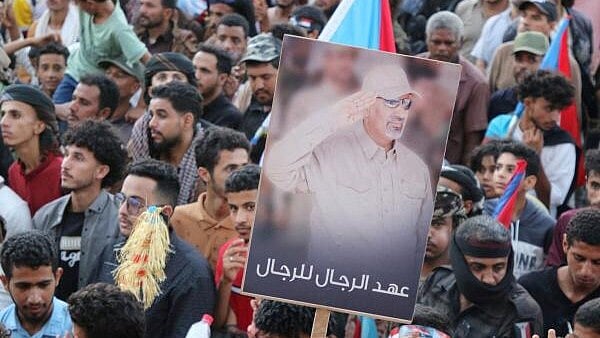 <div class="paragraphs"><p>Supporters of the UAE-backed separatist Southern Transitional Council (STC) hold a poster of Aidarous al-Zubaidi, the STC's leader, who, according to the Saudi-backed coalition, fled to an unknown destination, in Aden</p></div>