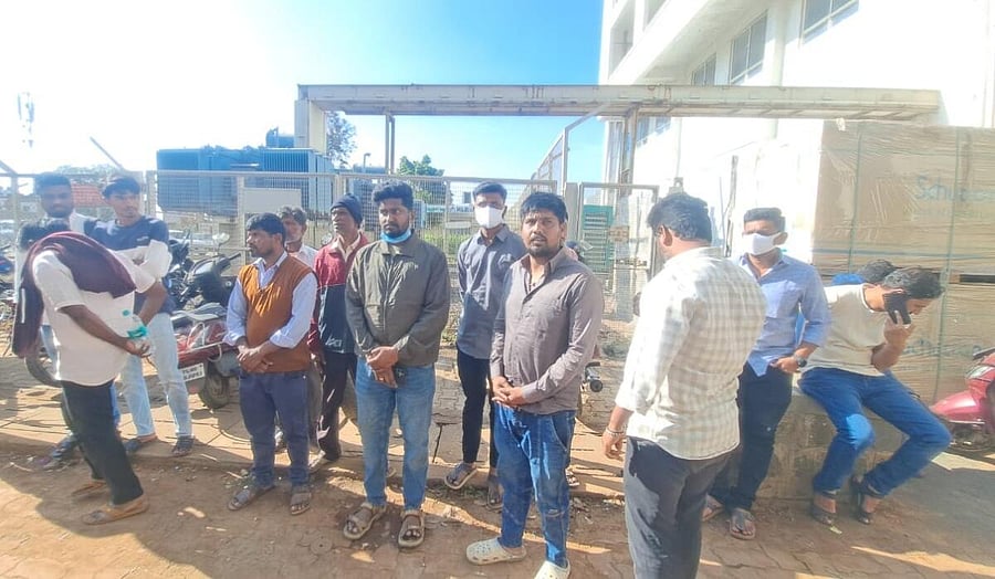 <div class="paragraphs"><p>Relatives of deceased workers wait in front of the morgue of KLE Hospital in Belgaum to collect their bodies on Thursday.</p></div>