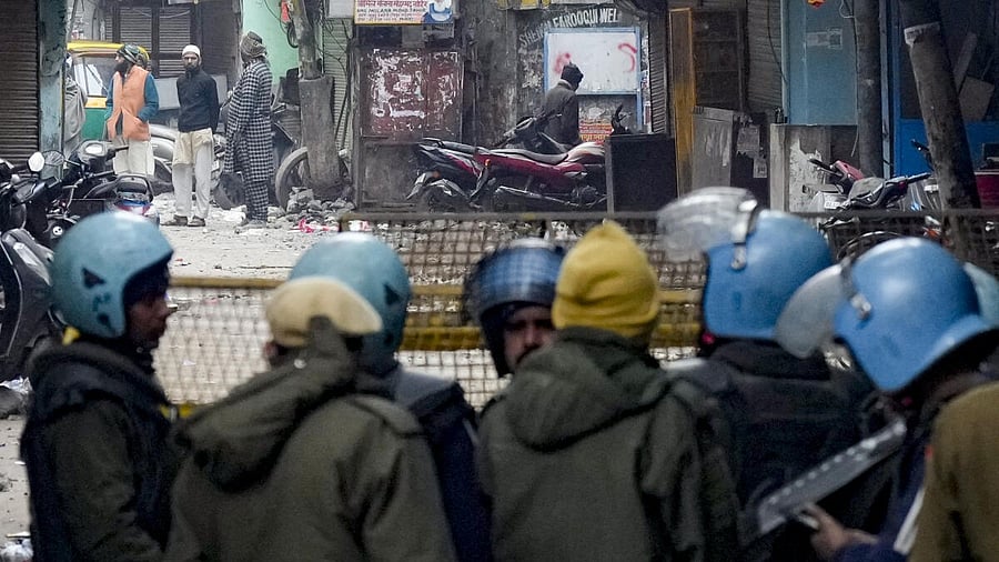 <div class="paragraphs"><p>Police and security personnel stand guard near the Syed Faiz Elahi mosque after the demolition of alleged encroachments from a land adjoining the mosque and a nearby graveyard carried out by the Municipal Corporation of Delhi (MCD), at Turkman Gate area, in New Delhi.</p></div>