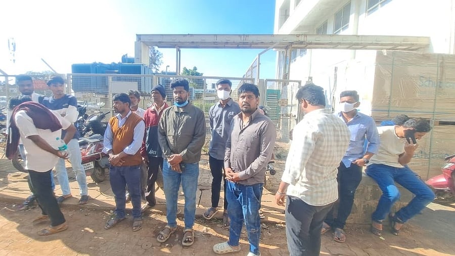 <div class="paragraphs"><p>The grieving family members of the deceased workers wait outside the mortuary of KLE Hospital in Belagavi to receive the bodies, on Thursday. </p></div>