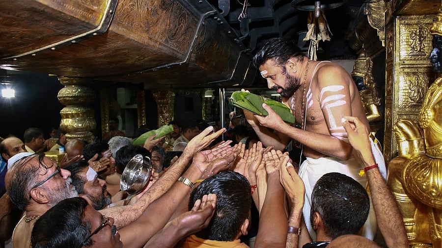 <div class="paragraphs"><p>Sabarimala head priest Kandararu Rajeevarau gives 'prasad' to devotee, at Sabarimala temple in Sabarimala. </p></div>
