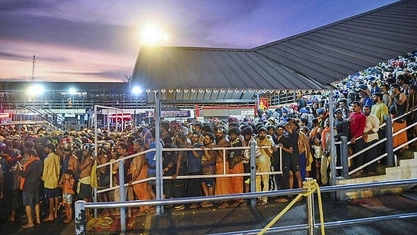 <div class="paragraphs"><p>Rush of people as they wait to offer prayers at the Sabarimala temple.</p></div>
