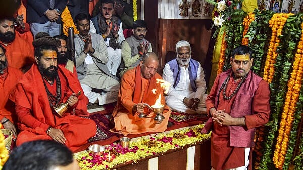 <div class="paragraphs"><p>Uttar Pradesh Chief Minister Yogi Adityanath, centre, with Mahant Balveer Giri at the ‘Bade Hanuman Ji’ temple during the 'Magh Mela' festival, in Prayagraj.</p></div>