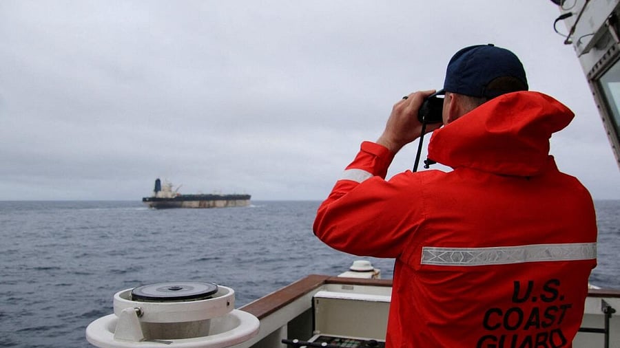 <div class="paragraphs"><p> A US Coast Guard official looks through binoculars at the ship Marinera (Ex-Bella 1)</p></div>