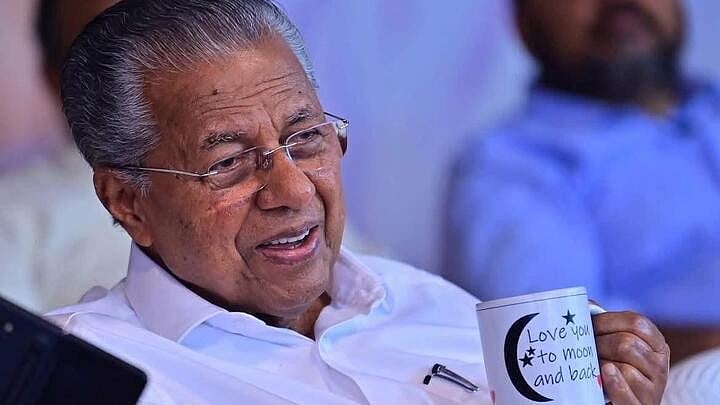 <div class="paragraphs"><p>Kerala CM Pinarayi Vijayan is seen holding a coffee mug with the message 'Love you to moon and back' written on it.&nbsp;</p></div>
