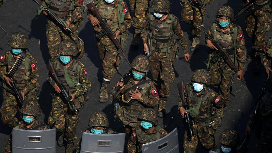 <div class="paragraphs"><p>Myanmar soldiers from the 77th light infantry division walk along a street during a protest against the military coup in Yangon, Myanmar, February 28, 2021.</p></div>