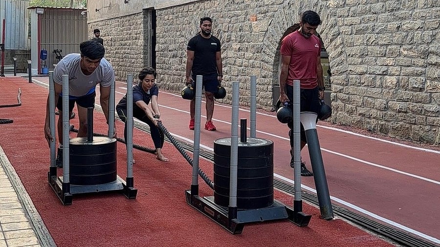 Hyrox aspirants practising workouts like sled pull, sled push, and farmer's carry at Hyfit, HSR Layout. 