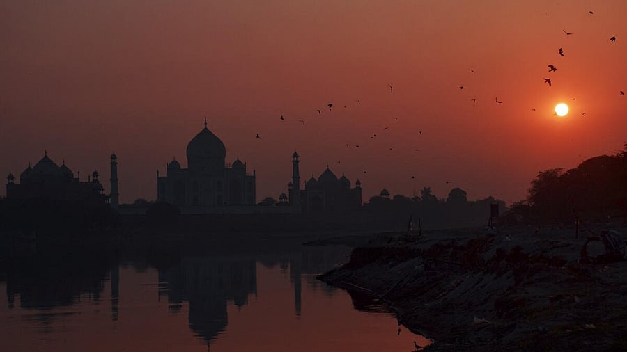 <div class="paragraphs"><p>Birds fly around the Taj Mahal silhouetted against the sunset, in Agra</p></div>