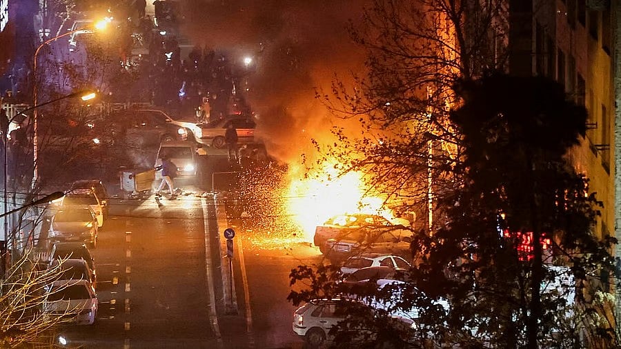 <div class="paragraphs"><p>Cars burn in a street during a protest in Iran. </p></div>