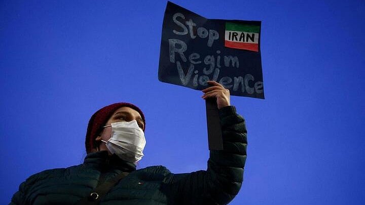 <div class="paragraphs"><p>A person shows a sign during a rally in support of nationwide protests in Iran</p></div>