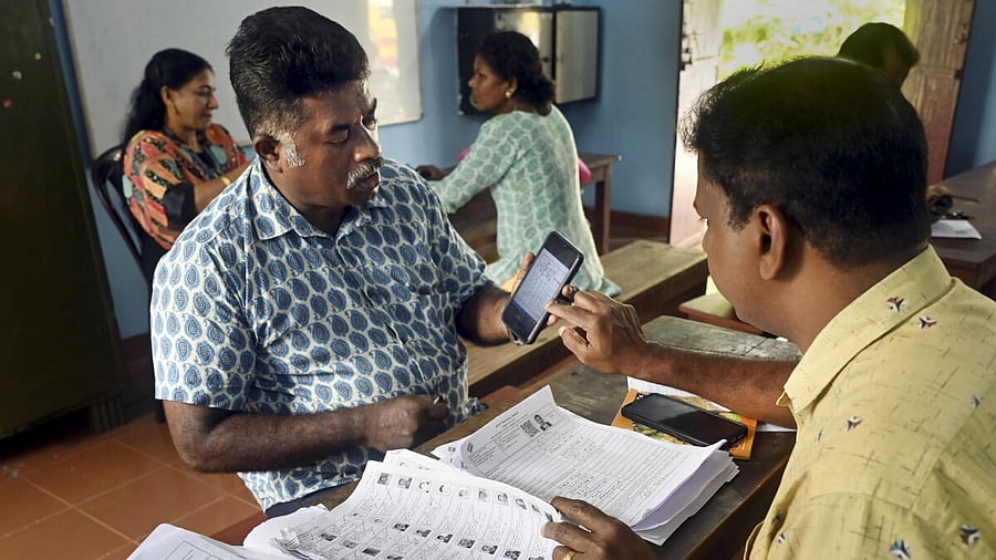 <div class="paragraphs"><p>A Booth Level Officer (BLO) interacts with a voter as he checks and collects filled enumeration forms for the special intensive revision (SIR) of electoral rolls, in Thiruvananthapuram.</p></div>