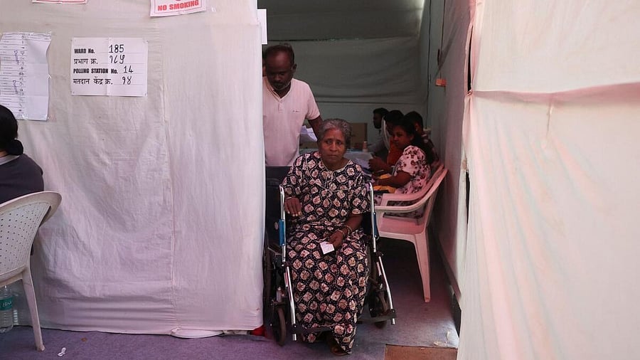 <div class="paragraphs"><p>A woman in a wheelchair leaves a polling booth after voting in the Brihanmumbai Municipal Corporation (BMC) elections in Mumbai.</p></div>