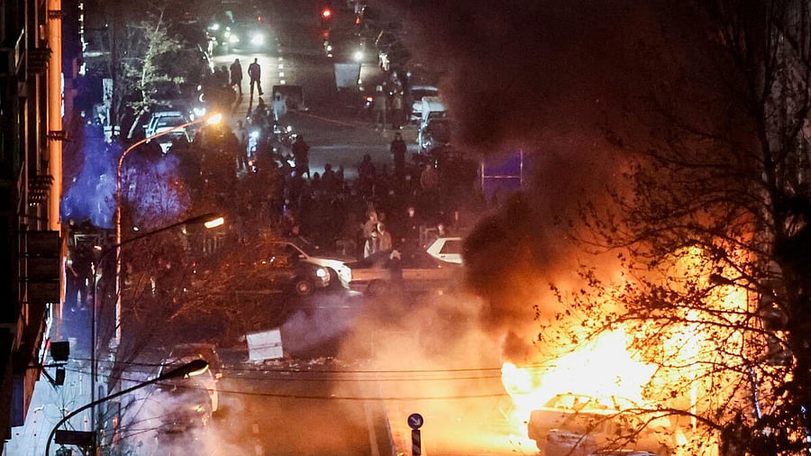 <div class="paragraphs"><p>Cars burn in a street during a protest </p></div>