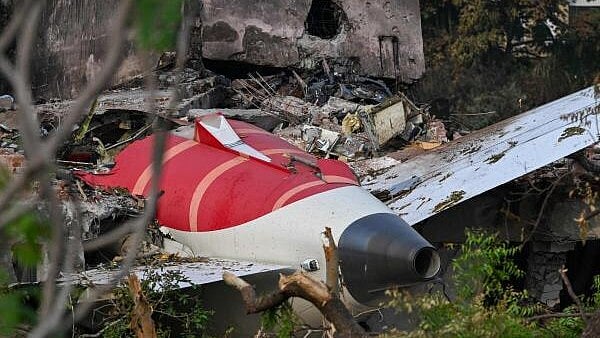 <div class="paragraphs"><p>Wreckage showing the tail section of the Air India Boeing 787-8 is pictured in a residential area near the airport in Ahmedabad.</p></div>