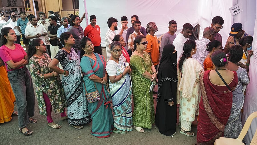 <div class="paragraphs"><p>People wait in queues outside a polling booth before casting their votes in the civic polls, in Mumbai, Thursday, Jan. 15, 2026.</p></div>