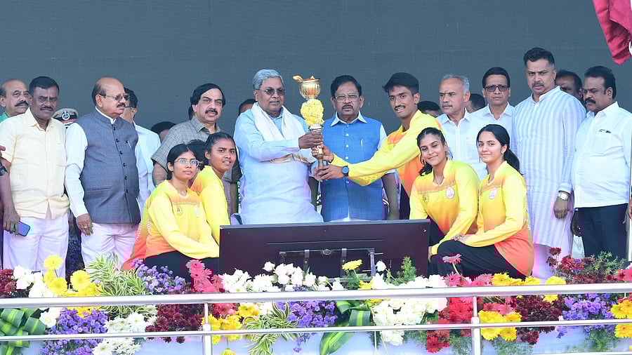 Chief Minister Siddaramaiah receives State Olympics torch from athletes during the inauguration ceremony at MG Stadium in Tumakuru on Friday. Home Minister G Parameshwara, KOA president K Govindaraju, legislators T B Jayachandra, B Sureshgowda, G B Jyothi Ganesh and others are seen.