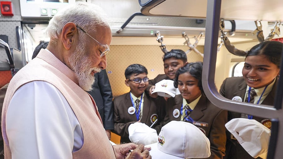 <div class="paragraphs"><p>Prime Minister Narendra Modi interacts with students during flagging off the country's first Vande Bharat sleeper train between Howrah and Guwahati (Kamakhya), in Malda, West Bengal.</p></div>