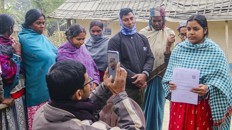 <div class="paragraphs"><p>A Booth level officer (BLO) clicks picture of a woman after handing over hearing notice under the Special Intensive Revision (SIR) of the electoral rolls.</p></div>