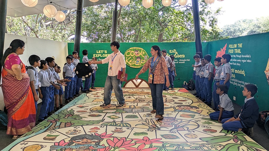 Pranav Rao, a student of commerce and investment banking, and Shri Gowri C G, who is studying early childhood care and education, facilitating a session for children at Makkala Hubba. 