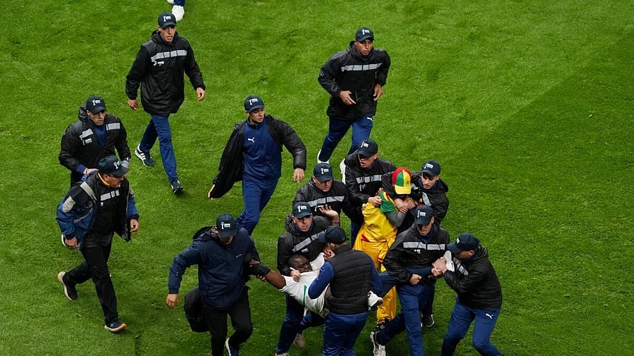 <div class="paragraphs"><p>Security staff tackle Senegal fans who invaded pitch after Morocco were awarded a penalty in the final.&nbsp;</p></div>