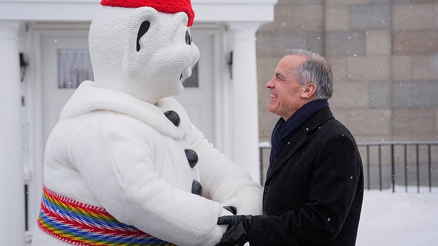 <div class="paragraphs"><p>Canada's Prime Minister Mark Carney interacts with Bonhomme Carnaval, mascot of the Quebec Winter Carnival, before a cabinet planning forum at the Citadelle in Quebec City. Reuters</p></div>