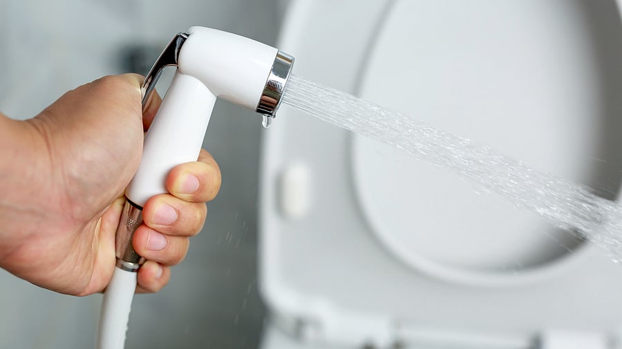 <div class="paragraphs"><p>Representative image of a white handheld bidet sprayer in toilet bathroom.</p></div>