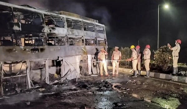 <div class="paragraphs"><p>Police personnel look on as firemen douse a fire after a private bus collided with a lorry and caught fire, near Sirivella Metta, in Nandyal district, Andhra Pradesh.</p></div>