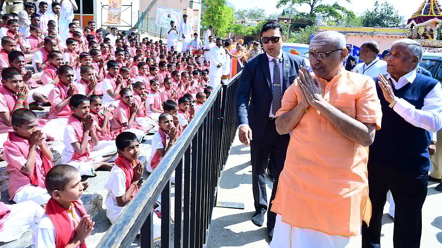 Vice President C P Radhakrishnan greets children while participating in the 7th death anniversary of Shivakumara Swami at Siddaganga Mutt in Tumakuru on Wednesday. Union Minister of State for Railways V Somanna is also seen.