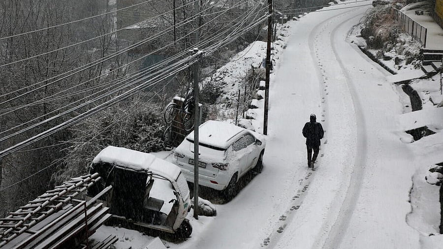 <div class="paragraphs"><p>A man walks through snow amid fresh snowfall at Bhaderwah, in Doda district, Jammu and Kashmir, Friday, Jan. 23, 2026.</p></div>