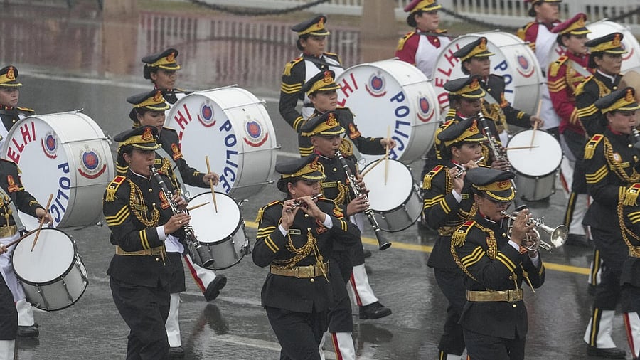 <div class="paragraphs"><p>Delhi Police Band marches during rain-affected full-dress rehearsal for the Republic Day Parade, in New Delhi.</p></div>